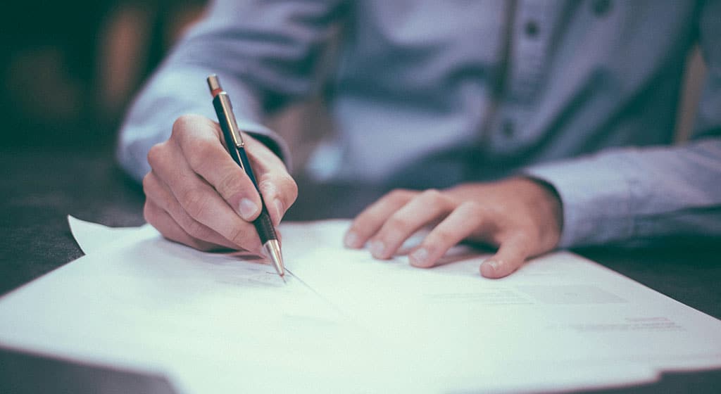 man-writing-on-paper-1024×560